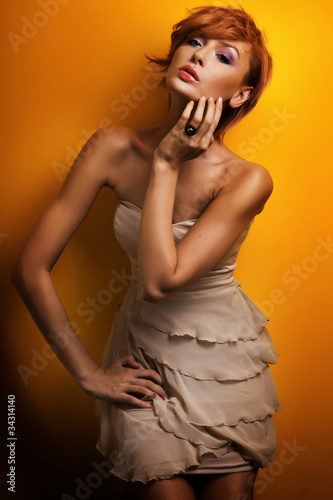 Photo: Fashion photo of beautiful redhead girl posing in sensual dress Fashion photo of beautiful redhead girl posing in sensual dress