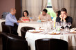 sad young man at restaurant table
