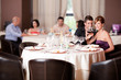 happy couple at restaurant table toasting