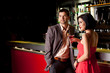 Photo : young couple at bar counter talking young couple at bar counter talking