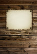 burnt paper tacked to a wood wall