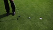 Golf player taking his put on a beautiful golfcourse