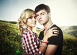 Photo: Portrait of love couple embracing outdoor in park Portrait of love couple embracing outdoor in park