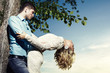 Photo: Portrait of love couple embracing outdoor in park Portrait of love couple embracing outdoor in park