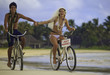 newlyywed couple on the beach with their bicycles