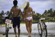 newlyywed couple on the beach with their bicycles