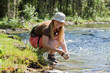 tourist washing utensil in  river