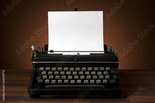 Photo: old typewriter with blank paper old typewriter with blank paper