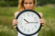young woman with a wall clock