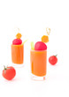 Vegetable juice in short glasses and tomatoes
