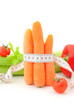 Carrots with tape measure and vegetables