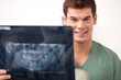 Photo: Happy Smiling Man Dentist Holding X-ray Happy Smiling Man Dentist Holding X-ray