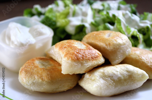 Photo: Perogies, Sour Cream & Side Salad Perogies, Sour Cream & Side Salad