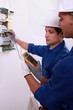 Electricians using multimeter