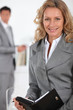 Female executive writing in diary