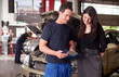 Mechanic and Customer Discussing Service Order