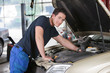 Mechanic Portrait Working on Car