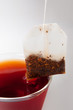 Teabag with cup of red fruit tea