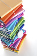 Photo: Mouse hanging from top of multi-colored book stack Mouse hanging from top of multi-colored book stack