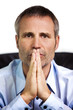 Close-up of confident businessman with folded hands.