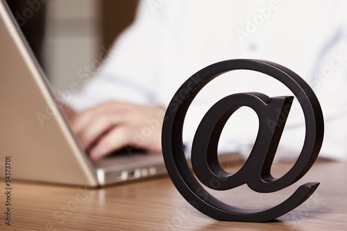 Photo: At symbol with laptop. At symbol with laptop.