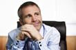 Foto: Optimistic businessman contemplating in office. Optimistic businessman contemplating in office.