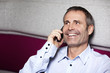 Happy business executive chatting on mobile phone.