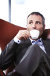 Closeup of businessman enjoying coffee.
