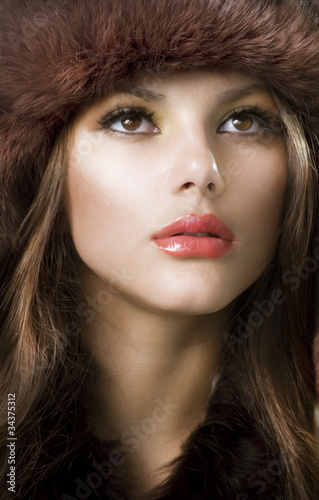 Photo: Beautiful Young Woman wearing Fur Hat. Winter Style Beautiful Young Woman wearing Fur Hat. Winter Style
