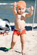 young boy playing in the sand on the beach