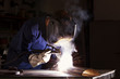 Foto: Worker welding in workshop. Worker welding in workshop.