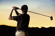 Golfer teeing off at sunset. Golfer teeing off at sunset.