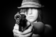 Girl in hat with a big pistol