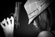 Girl in hat with a big pistol