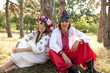Slav girl with wreath and young cossack at nature