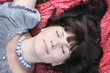 Attractive girl, lying on a travelling rug Attractive girl, lying on a travelling rug