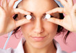 Closeup portrait of young nurse showing pills over eyes