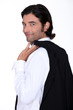 Roguish gent holding his jacket over his shoulder