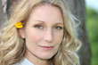 blonde woman with flower in hair