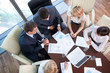Foto: Business people at the negotiating table in the office Business people at the negotiating table in the office