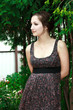 Beautiful girl among the fir trees with romantic sight looking Beautiful girl among the fir trees with romantic sight looking