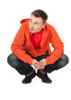 squats young man in orange sweatshirt, full length, series