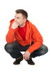 squats young man in orange sweatshirt  full length, series