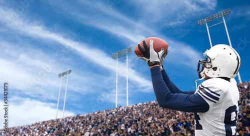 Photo: American Football Player catching a touchdown pass American Football Player catching a touchdown pass