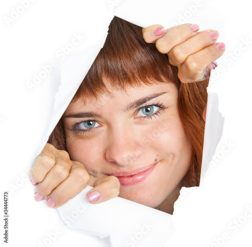 Photo: Girl is looking through a hole Girl is looking through a hole