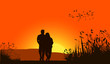 Loving couple against a sunset sky