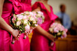 Row of bridesmaids with bouquets at wedding ceremony