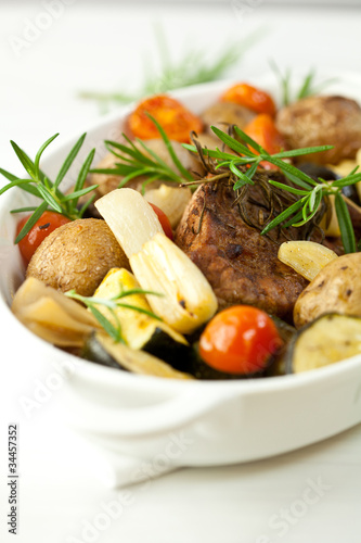 Photo: Rustic meat dish with rosemary sprigs Rustic meat dish with rosemary sprigs