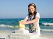Child Building Sandcastle on a Beach