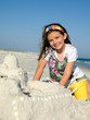 Child Building Sandcastle on a Beach